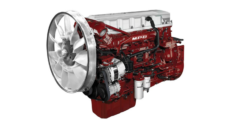 A red and silver Mack MP8 engine, side corner view with cooling fan visible
