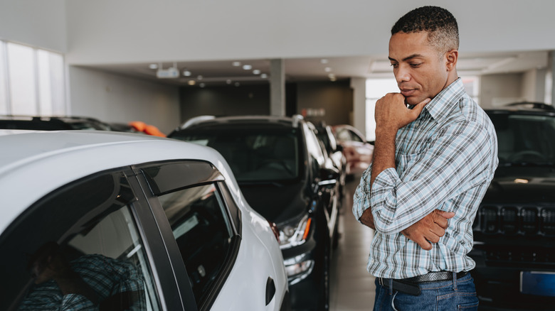 A man looking at a car
