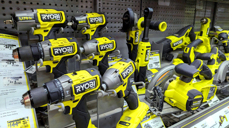 A store shelf with several Ryobi tools