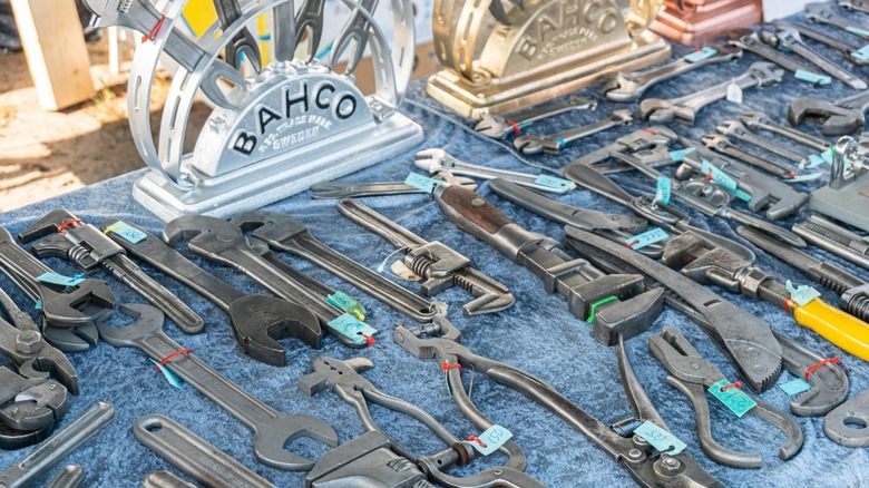 A collection of used tools at a garage sale