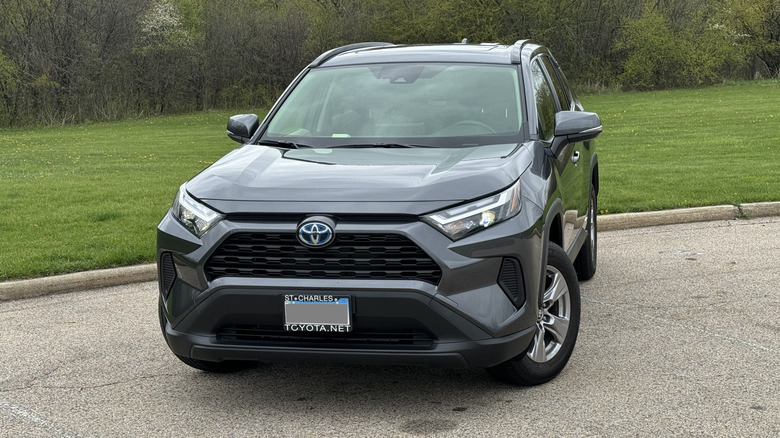 Toyota Rav4 Hybrid in a parking lot by a field
