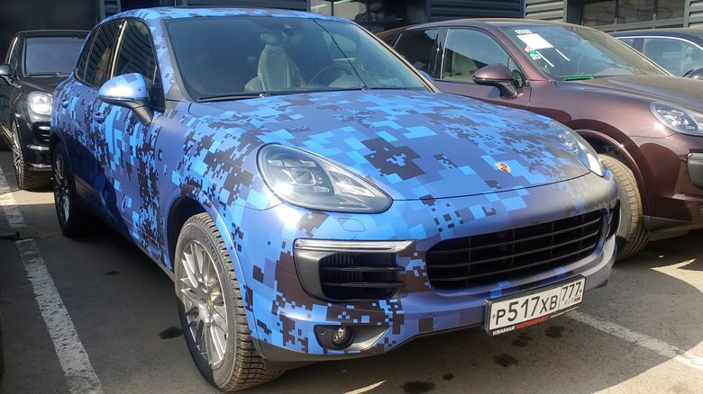 A Porsche Cayenne wrapped in a blue pixelated pattern.