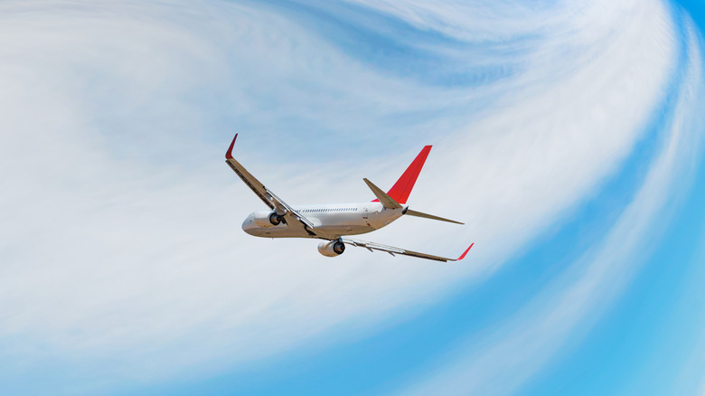 A white aircraft flying in the air.